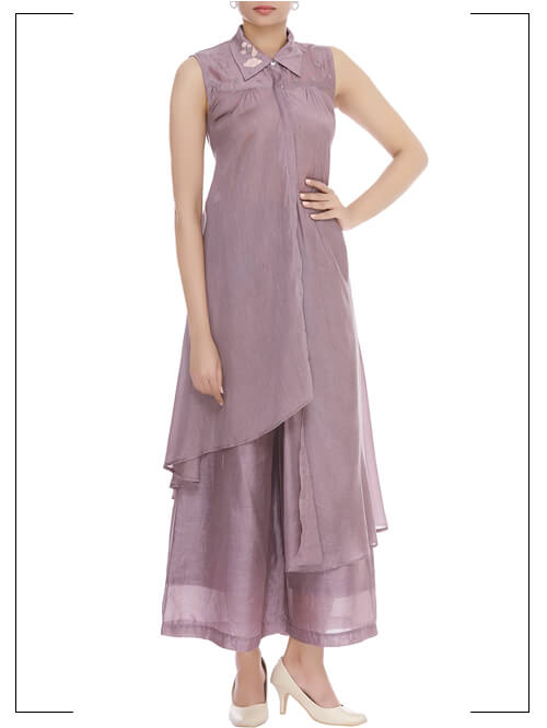 A modern-traditional silhouette is this lilac silk Asymmetric hemline embroidered shirt tunic paired with matching palazzo pants.